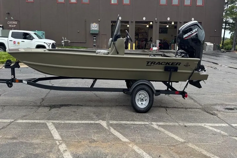 Slide: The Image of 2026 Tracker Grizzly 1860 CC boat on trailer, parked outside a building. - 4