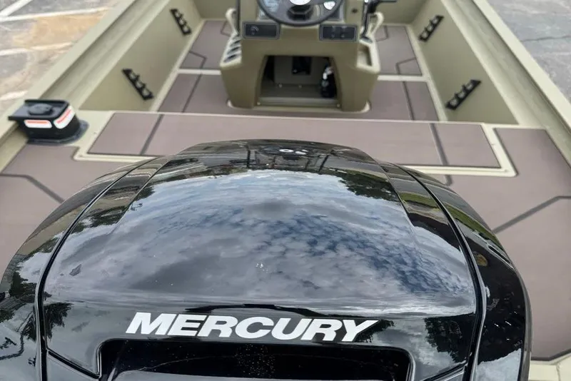 Slide: The Image of 2026 Tracker Grizzly 1860 CC boat with Mercury engine, interior view. - 5