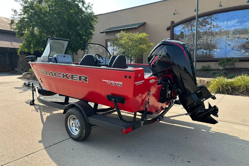 Slide: The Image of 2026 Tracker Pro Guide V-175 WT boat on trailer, red exterior, parked outdoors. - 2