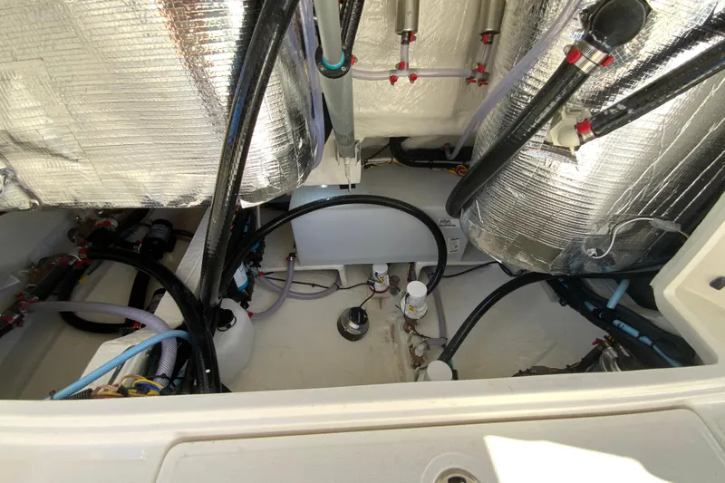 Slide: The Image of Engine compartment of 2026 Cobia 305 Center Console boat with insulated components and wiring. - 106