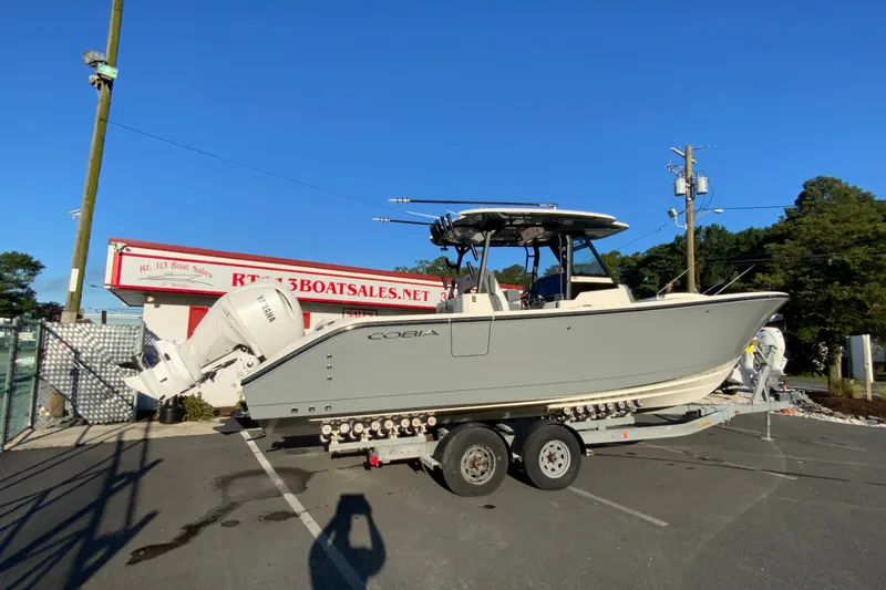 Slide: The Image of 2026 Cobia 305 Center Console boat on trailer at dealership. - 13