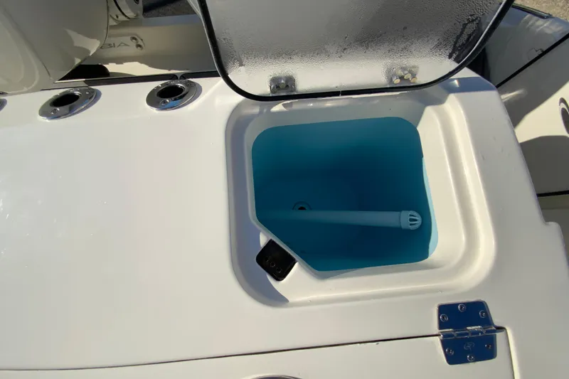 Slide: The Image of Livewell compartment on 2026 Cobia 305 Center Console boat, featuring a blue interior. - 19
