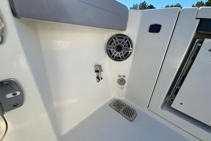Slide: The Image of 2026 Cobia 305 Center Console boat interior with speaker and drainage system. - 22