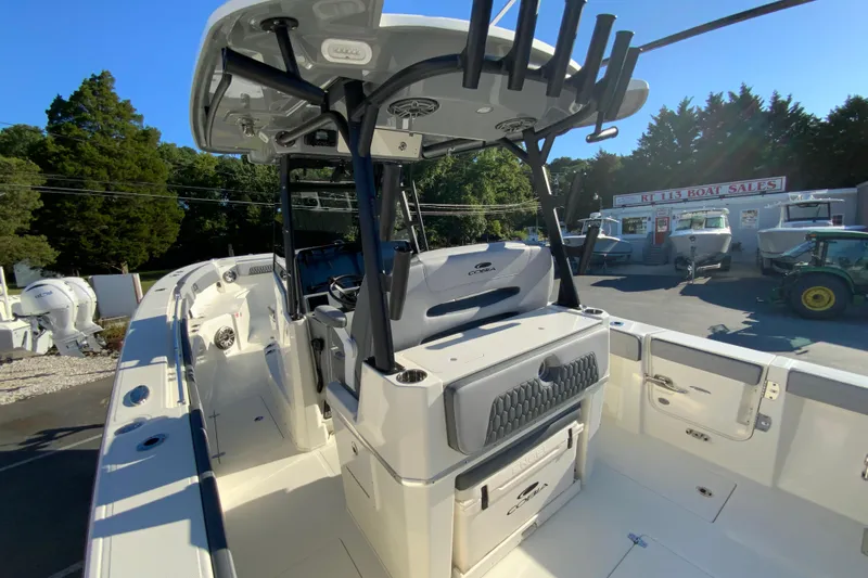 Slide: The Image of 2026 Cobia 305 Center Console boat at dealership, showcasing spacious deck and modern design. - 28