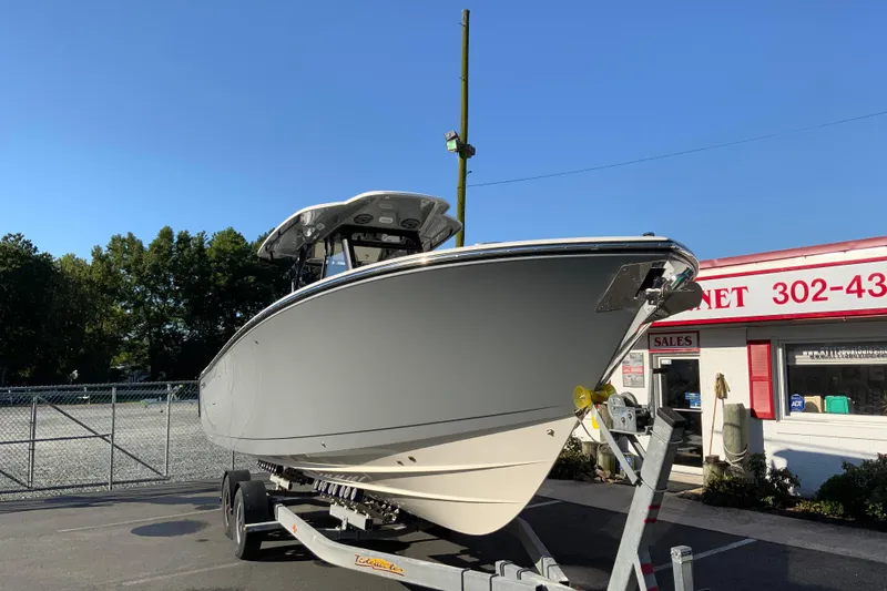 Slide: The Image of 2026 Cobia 305 Center Console boat on trailer at dealership. - 3