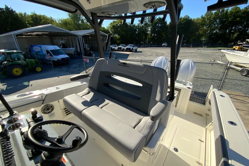 Slide: The Image of 2026 Cobia 305 Center Console boat interior with seating and steering wheel. - 38