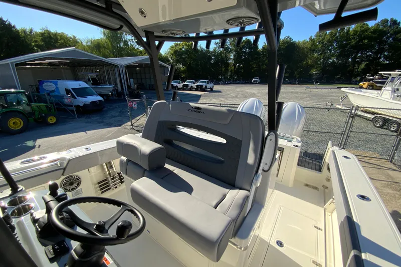 Slide: The Image of 2026 Cobia 305 Center Console boat interior with steering wheel and seating. - 39