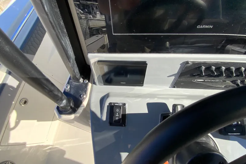 Slide: The Image of 2026 Cobia 305 Center Console dashboard with Garmin display and controls. - 46