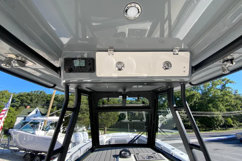 Slide: The Image of 2026 Cobia 305 Center Console boat interior with control panel and storage compartments. - 49