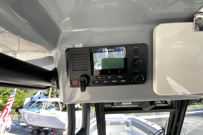 Slide: The Image of Garmin marine radio on 2026 Cobia 305 Center Console boat dashboard. - 50