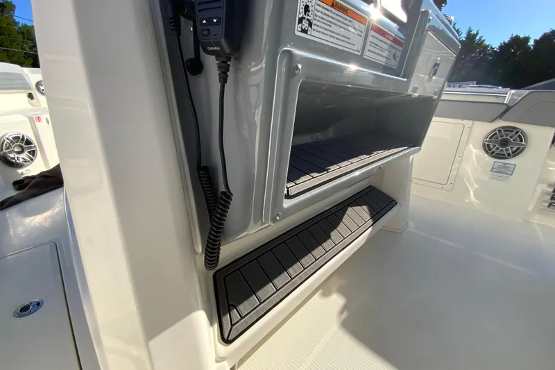 Slide: The Image of 2026 Cobia 305 Center Console interior with storage compartments and marine electronics. - 54