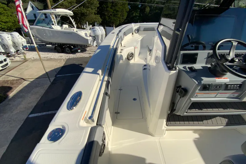 Slide: The Image of 2026 Cobia 305 Center Console boat interior with helm and seating area. - 55