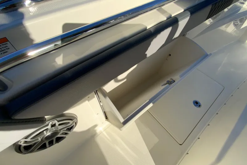 Slide: The Image of 2026 Cobia 305 Center Console boat interior storage compartment and speaker detail. - 57
