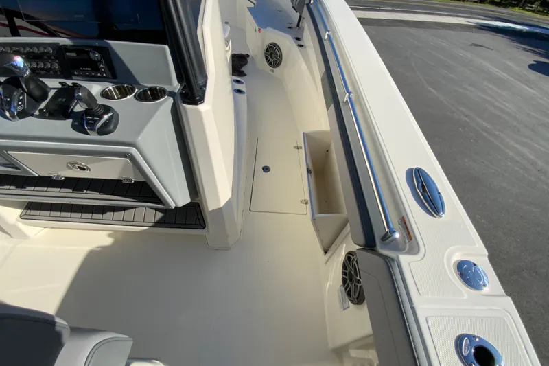 Slide: The Image of 2026 Cobia 305 Center Console boat interior with control panel and storage compartments. - 62