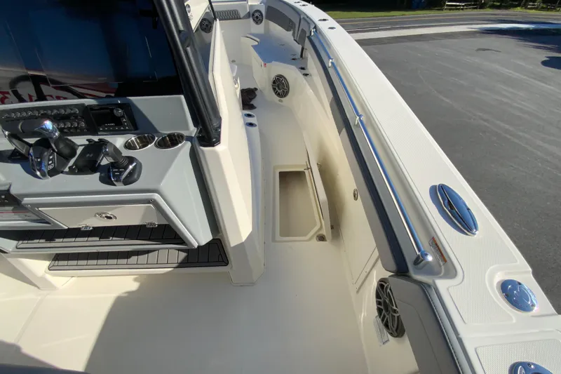 Slide: The Image of 2026 Cobia 305 Center Console boat interior with control panel and seating area. - 64