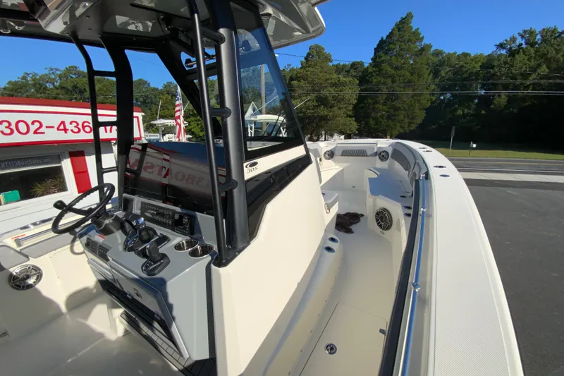 Slide: The Image of 2026 Cobia 305 Center Console boat interior with steering wheel and controls. - 66