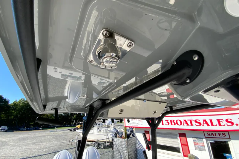 Slide: The Image of 2026 Cobia 305 Center Console boat detail at dealership, showcasing sturdy construction. - 73