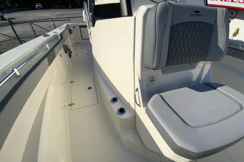 Slide: The Image of 2026 Cobia 305 Center Console boat interior with cushioned seating and sleek design. - 75