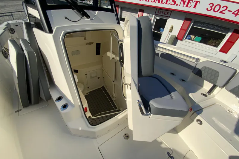 Slide: The Image of 2026 Cobia 305 Center Console boat interior with open storage compartment and seating. - 77