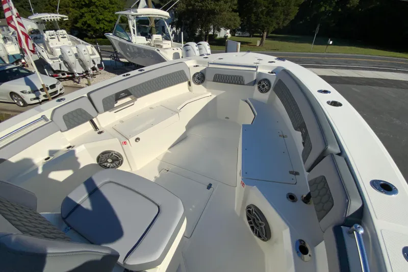 Slide: The Image of 2026 Cobia 305 Center Console boat interior with seating and speakers. - 82