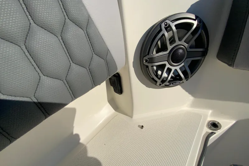 Slide: The Image of 2026 Cobia 305 Center Console interior with speaker and quilted seat detail. - 83