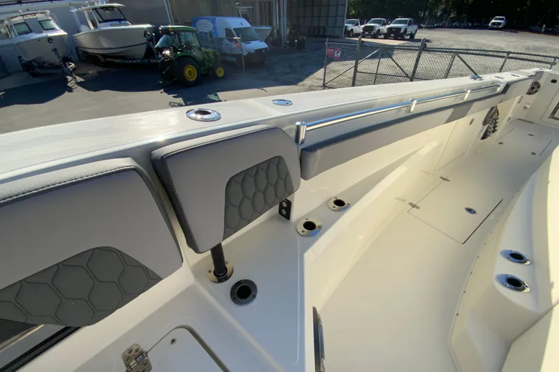 Slide: The Image of 2026 Cobia 305 Center Console boat interior with seating and rod holders. - 86