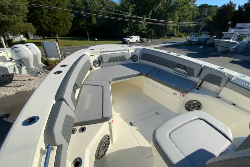 Slide: The Image of 2026 Cobia 305 Center Console boat interior with cushioned seating and modern design. - 89