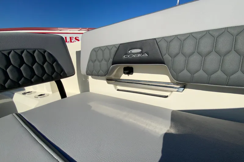 Slide: The Image of 2026 Cobia 305 Center Console boat seat with logo, featuring stylish upholstery design. - 95