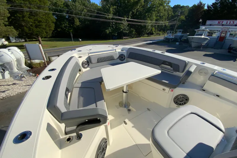 Slide: The Image of 2026 Cobia 305 Center Console boat with spacious seating and table setup. - 99