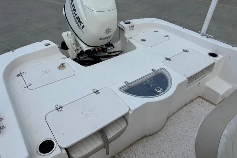 Slide: The Image of 2019 Carolina Skiff 218 DLV boat deck with Suzuki 140 outboard motor. - 16