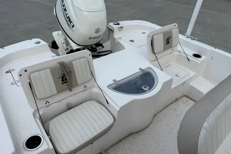 Slide: The Image of 2019 Carolina Skiff 218 DLV boat interior with Suzuki 140 outboard motor. - 17