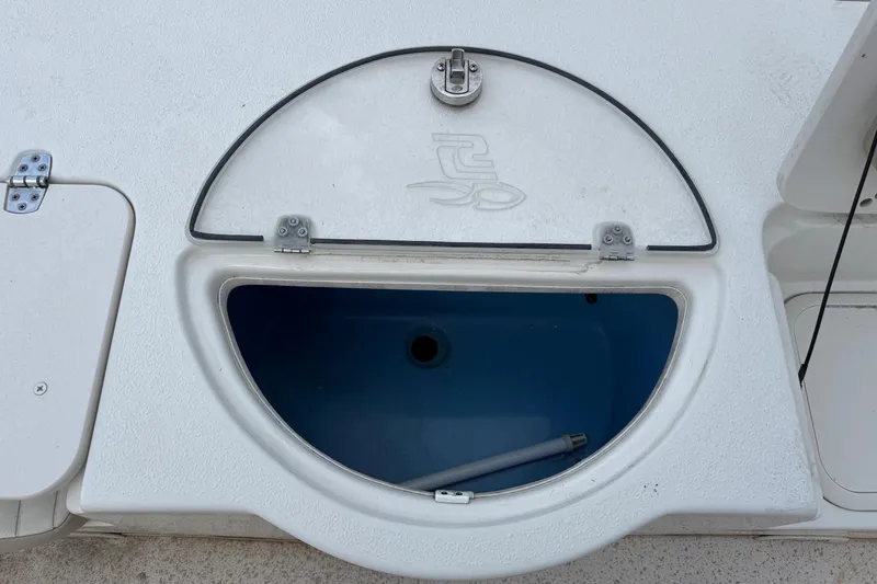 Slide: The Image of 2019 Carolina Skiff 218 DLV boat storage compartment with open lid. - 18