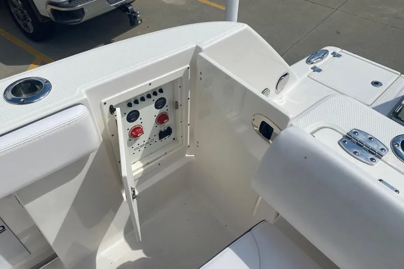 Slide: The Image of 2021 Robalo R272 Center Console boat with open control panel and seating area. - 13