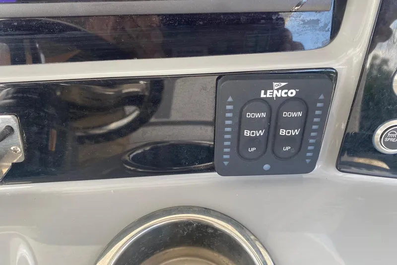 Slide: The Image of Control panel of a 2021 Robalo R272 Center Console boat with Lenco trim tab switches. - 16