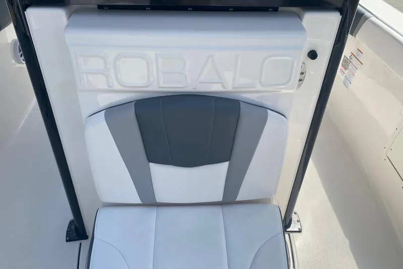 Slide: The Image of 2021 Robalo R272 Center Console boat seat with logo, white and gray upholstery. - 4