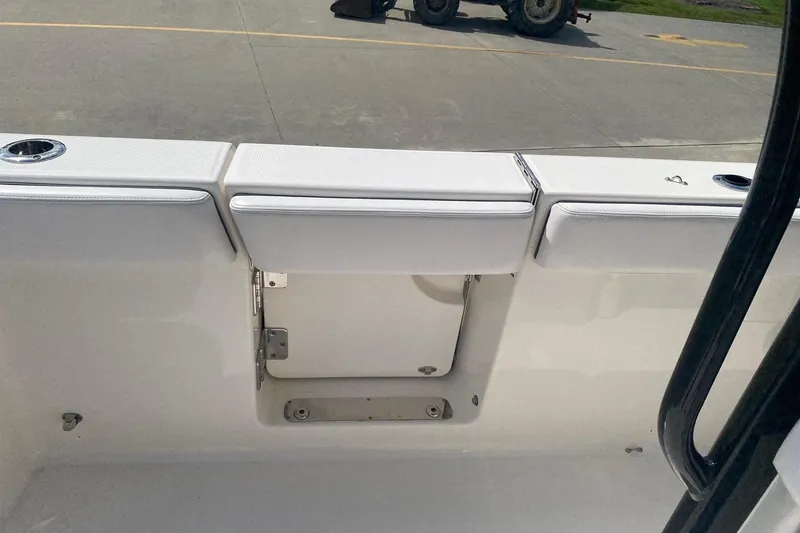 Slide: The Image of 2021 Robalo R272 Center Console boat interior with seating and storage compartment. - 8
