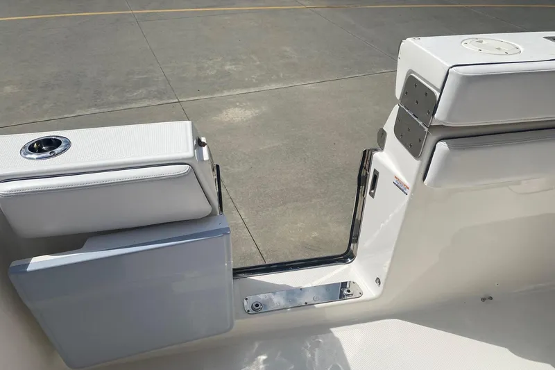 Slide: The Image of 2021 Robalo R272 Center Console boat with open side door on deck. - 9