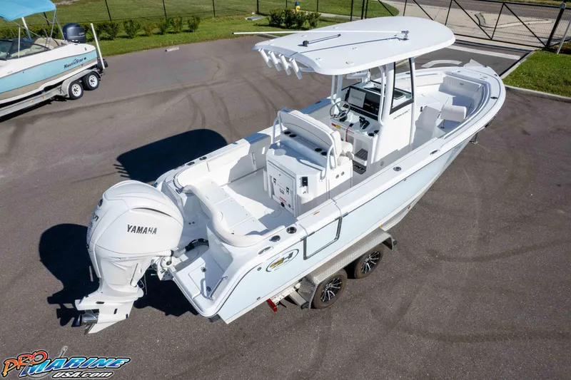 Slide: The Image of 2025 Sea Hunt Ultra 245 SE boat with Yamaha engine on a trailer. - 14
