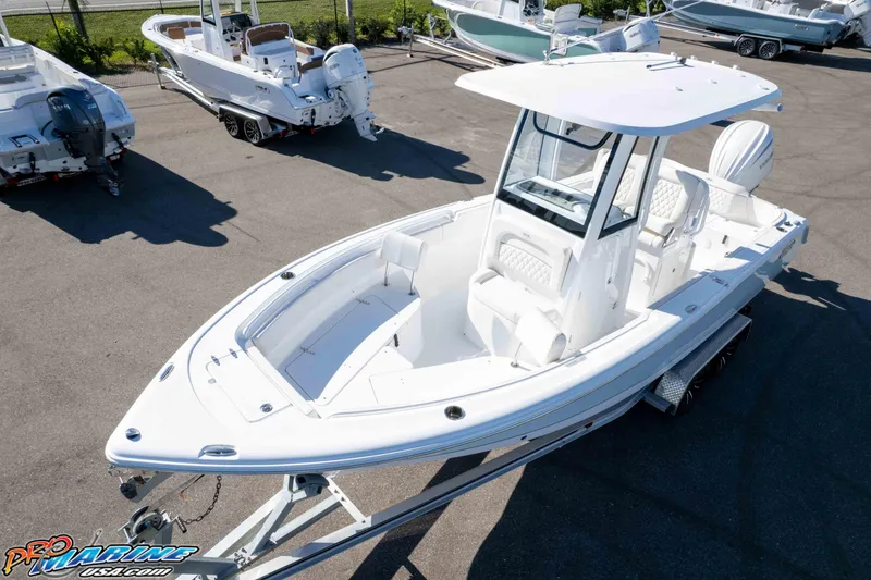 Slide: The Image of 2025 Sea Hunt Ultra 245 SE boat on trailer in marina lot. - 2