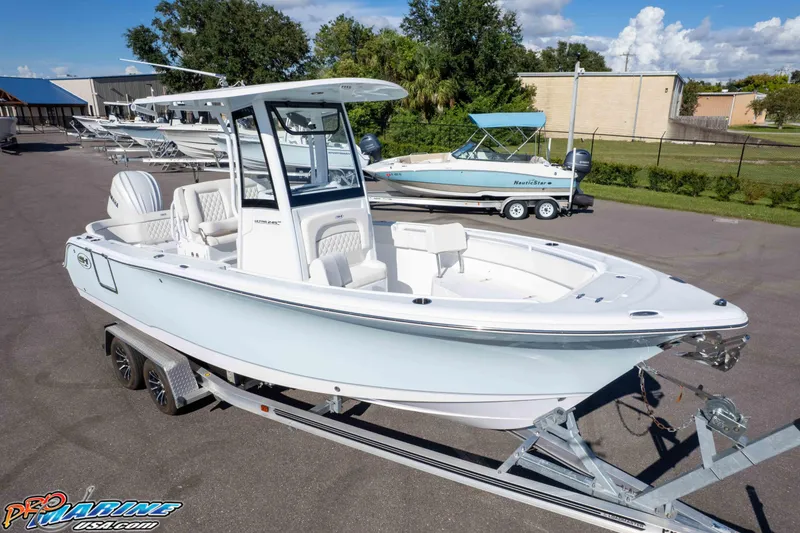 Slide: The Image of 2025 Sea Hunt Ultra 245 SE boat on trailer, displayed outdoors at dealership. - 21