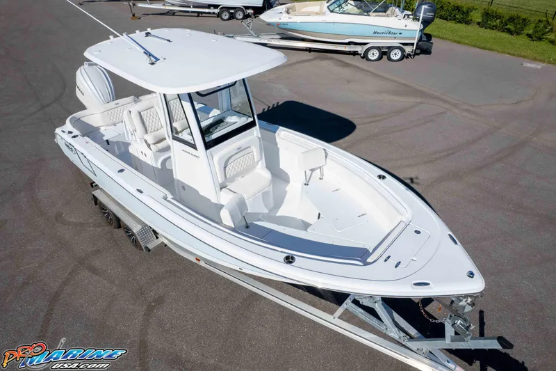 Slide: The Image of 2025 Sea Hunt Ultra 245 SE boat on trailer, aerial view, in parking lot. - 23