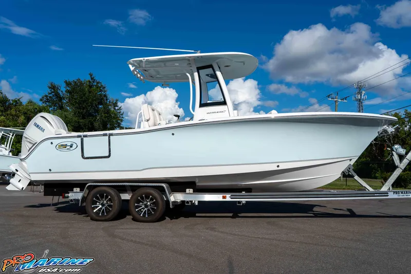 Slide: The Image of 2025 Sea Hunt Ultra 245 SE boat on trailer under blue sky. - 34
