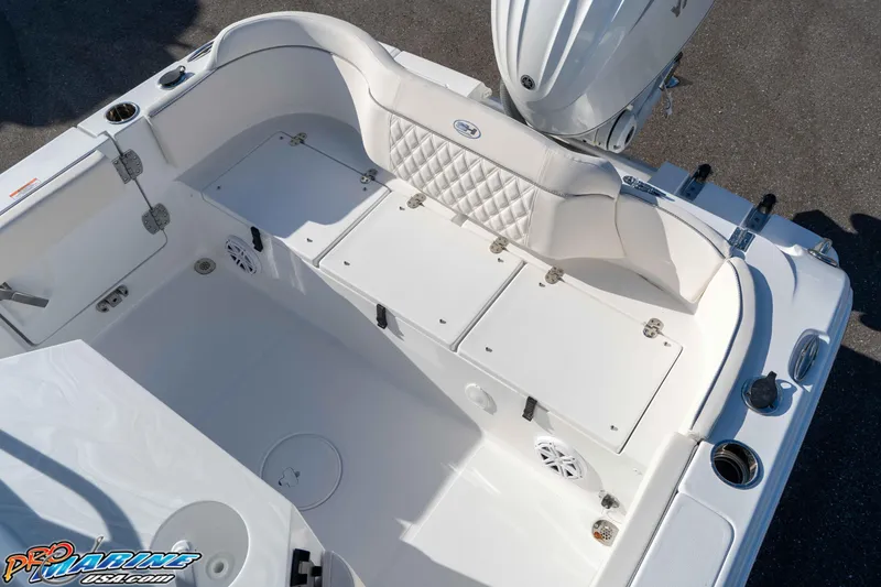 Slide: The Image of 2025 Sea Hunt Ultra 245 SE boat interior with white seating and storage compartments. - 39