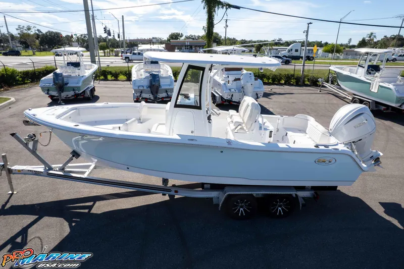 Slide: The Image of 2025 Sea Hunt Ultra 245 SE boat on trailer in parking lot. - 4