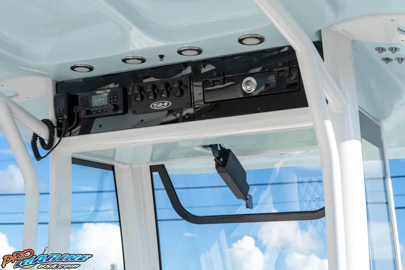 Slide: The Image of 2025 Sea Hunt Ultra 245 SE boat console with electronic controls and radio system. - 42