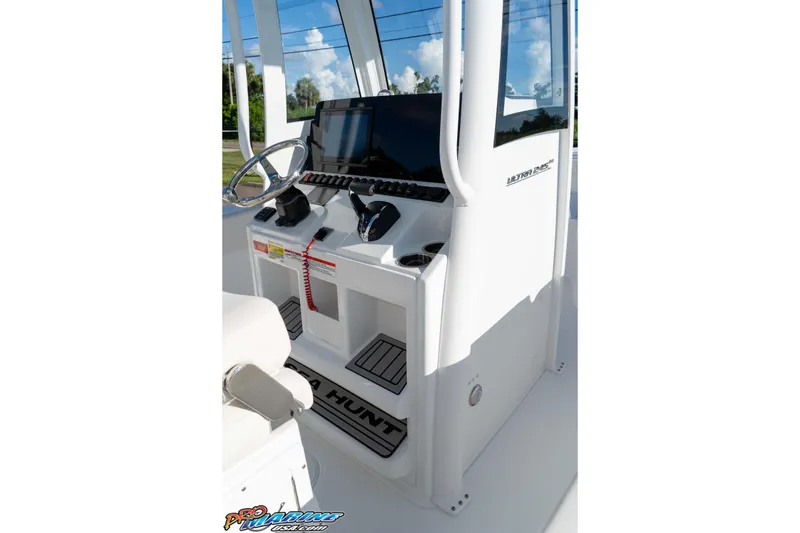 Slide: The Image of 2025 Sea Hunt Ultra 245 SE boat console with steering wheel and controls. - 44