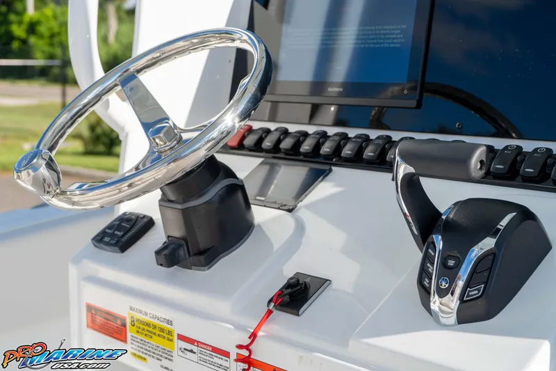 Slide: The Image of Steering console of 2025 Sea Hunt Ultra 245 SE boat with controls and display. - 46