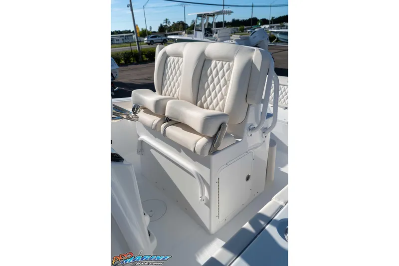Slide: The Image of 2025 Sea Hunt Ultra 245 SE boat seating with white cushioned seats and diamond stitching. - 47