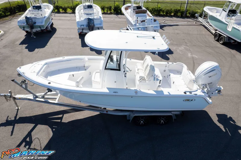 Slide: The Image of 2025 Sea Hunt Ultra 245 SE boat on trailer, aerial view, in a parking lot. - 5