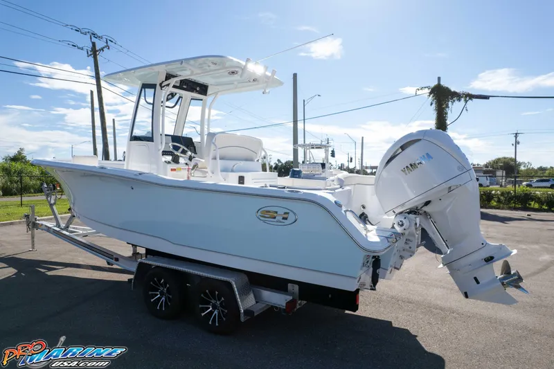 Slide: The Image of 2025 Sea Hunt Ultra 245 SE boat on trailer, featuring Yamaha outboard motor. - 6